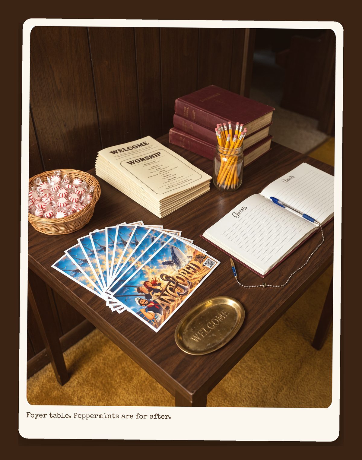 Welcome table with bulletins, hymnals, peppermints and a pen on a chain