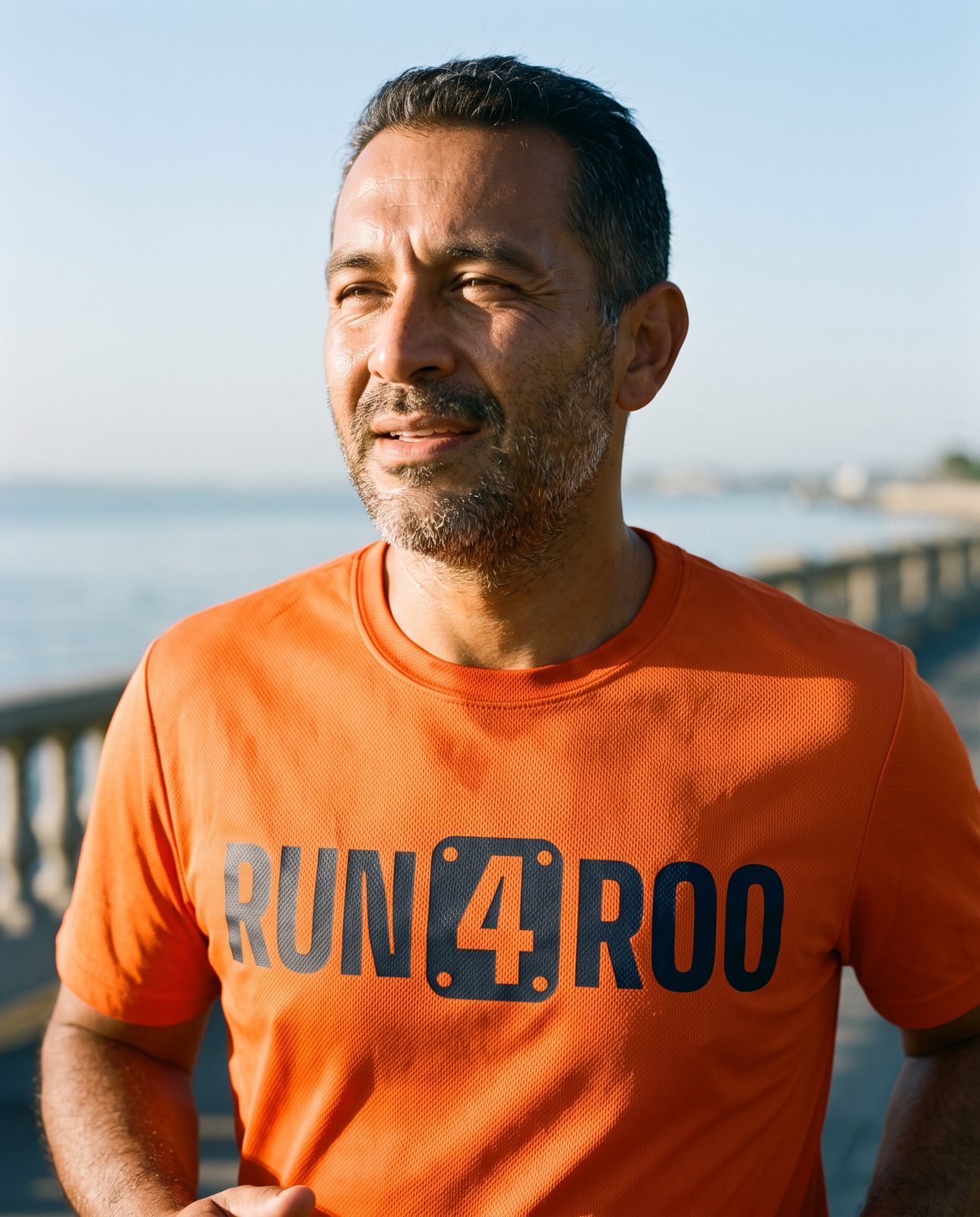 Runner wearing the Run4Roo team shirt with the bib-4 wordmark