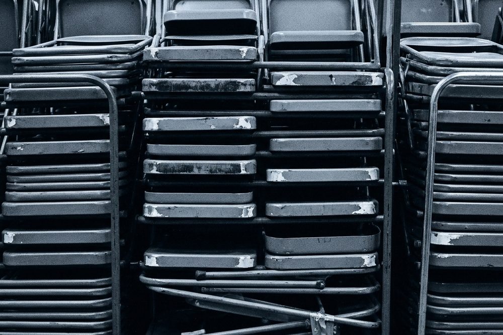Stacked folding chairs, blue duotone